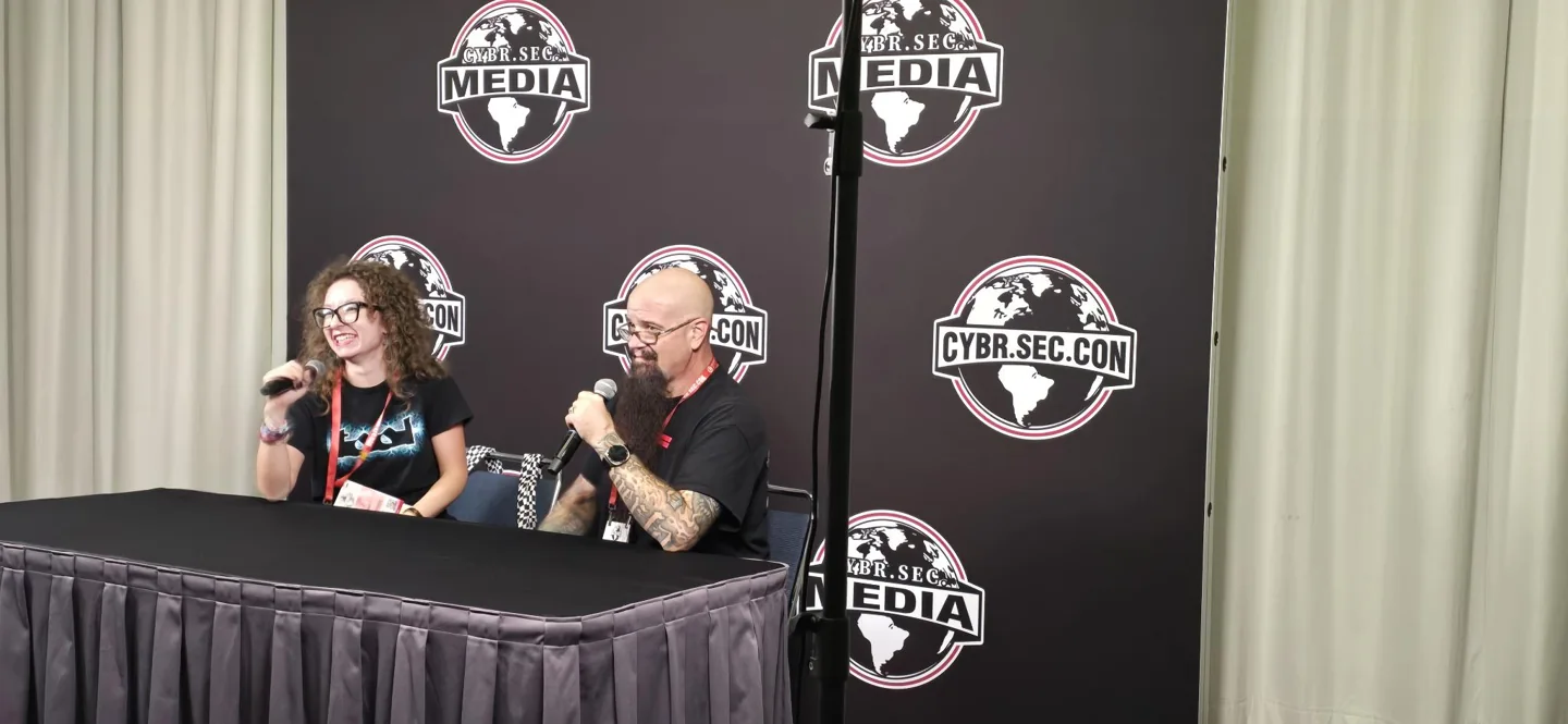 Lindsey in a microphone conversation at the CYBR.SEC.CON media area in Houston.